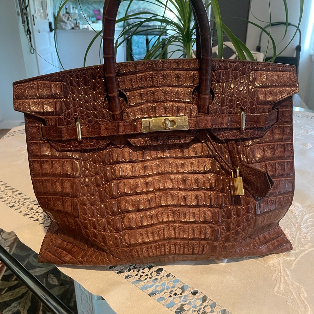 Genuine Brown croc leather with brass fittings.